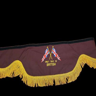 Maroon fabric truck pelmet with gold fringe and “Only Way Is British” embroidered design. Whiterig Truck Curtains